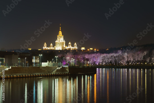 Long exposure photography of the Vorobyevy Gory / Gorky park in the autumn night. Moscow State University of Stalinist neoclassical style named after Lomonosov in distance. 