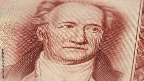 Johann Wolfgang von Goethe portrait on East German 20 mark (1964) banknote rotating. Low angle, macro. 4K, 422 10 bit photo
