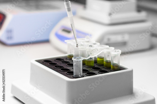 Green substance in microtube is put in thermo shaker. DNA experiment in biochemical laboratory photo