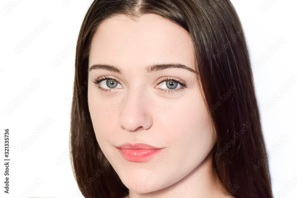 Portrait of a dark haired caucasian girl on a white background. The face of a young woman close-up. Portrait of a dark haired caucasian girl on a white background. The face of a young woman close-up.