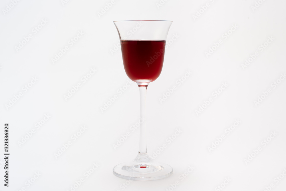 Elegant glass with liquor on a neutral gray background Elegant glass with liquor on a neutral gray background