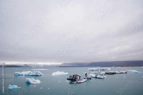 Icebergs in Jokulsarlon lagoon beneath Breidamerkurjokull glacier Sudhurland, Iceland. Place for text or advertising