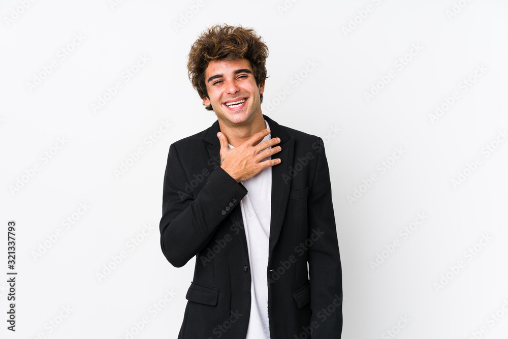 Young caucasian business man against a white background isolated laughs out loudly keeping hand on chest.