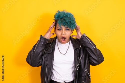 young urban hipster girl isolated on yellow background © carballo