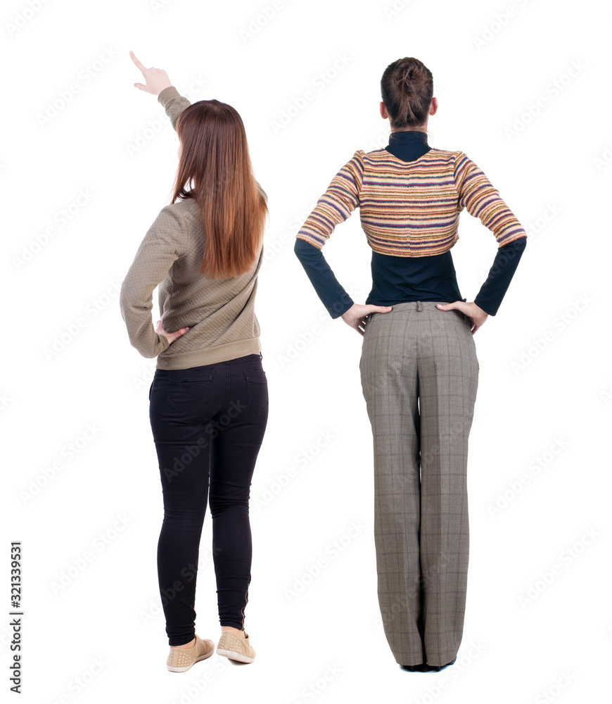 Back view of two pointing young girl in sweater. Back view of two pointing young girl in sweater.
