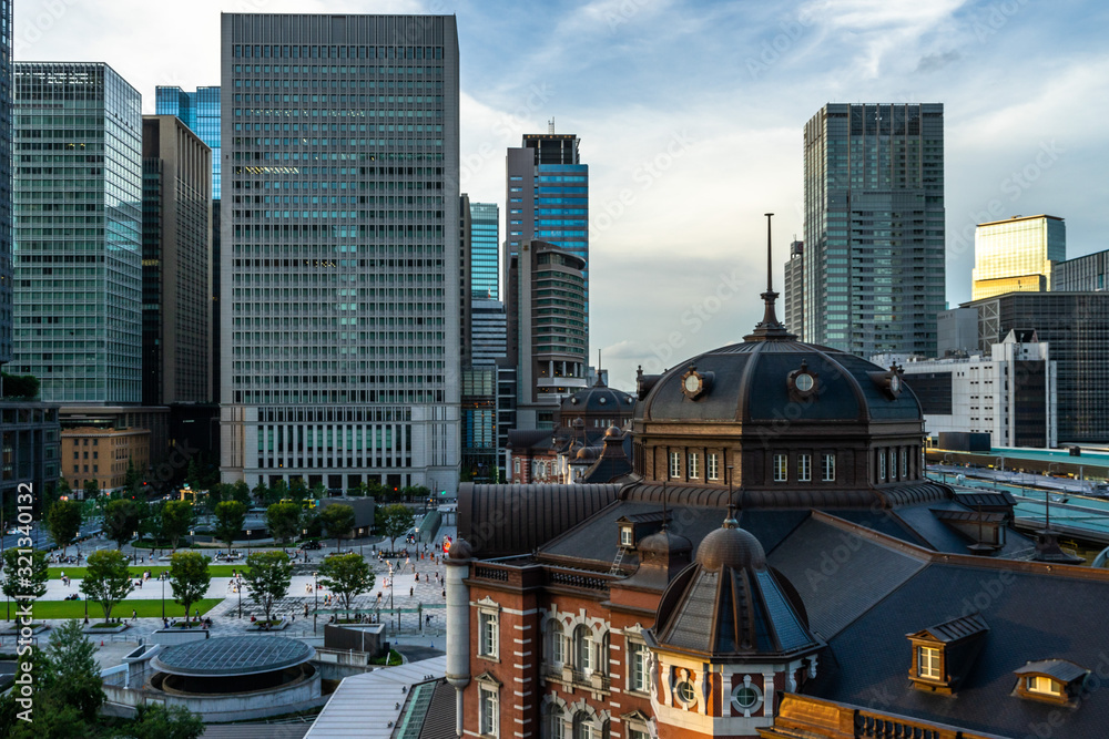 Dome of Tokyo Station building with skyscraper of Chiyoda business district in the background Dome of Tokyo Station building with skyscraper of Chiyoda business district in the background