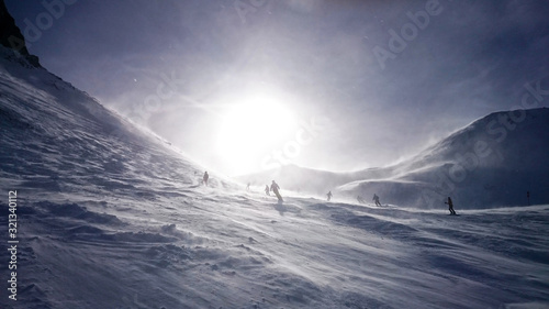 Storm on the ski slopes. Wind on top of the mountains. photo