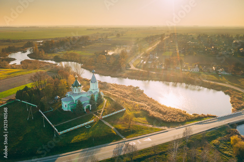 Krupets, Dobrush District, Gomel Region, Belarus. Aerial View Of Old Wooden Orthodox Church Of The Holy Trinity At Sunny Autumn Day photo