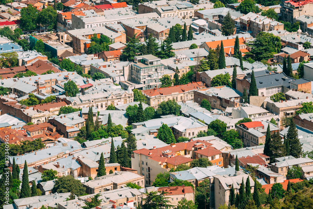 Tbilisi Georgia. Aerial View Of Residential Area. Buildings With Red White Roofs And Green Trees