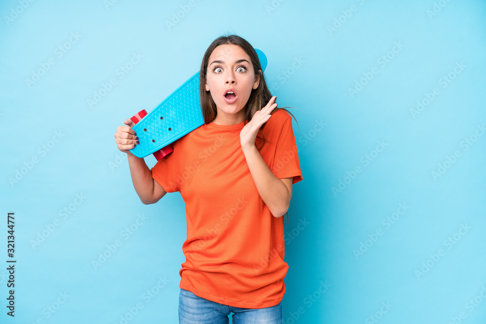 Young caucasian skater woman isolated surprised and shocked. Young caucasian skater woman isolated surprised and shocked.