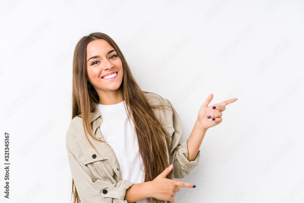 Young caucasian woman isolated excited pointing with forefingers away. Young caucasian woman isolated excited pointing with forefingers away.