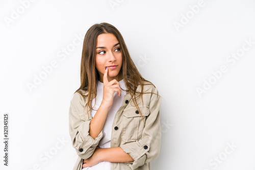 Young caucasian woman  isolated looking sideways with doubtful and skeptical expression.