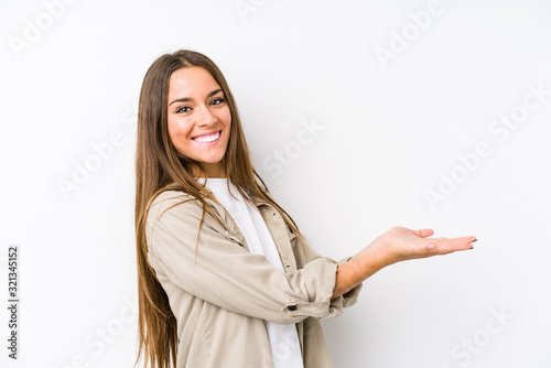 Young caucasian woman  isolated holding a copy space on a palm.
