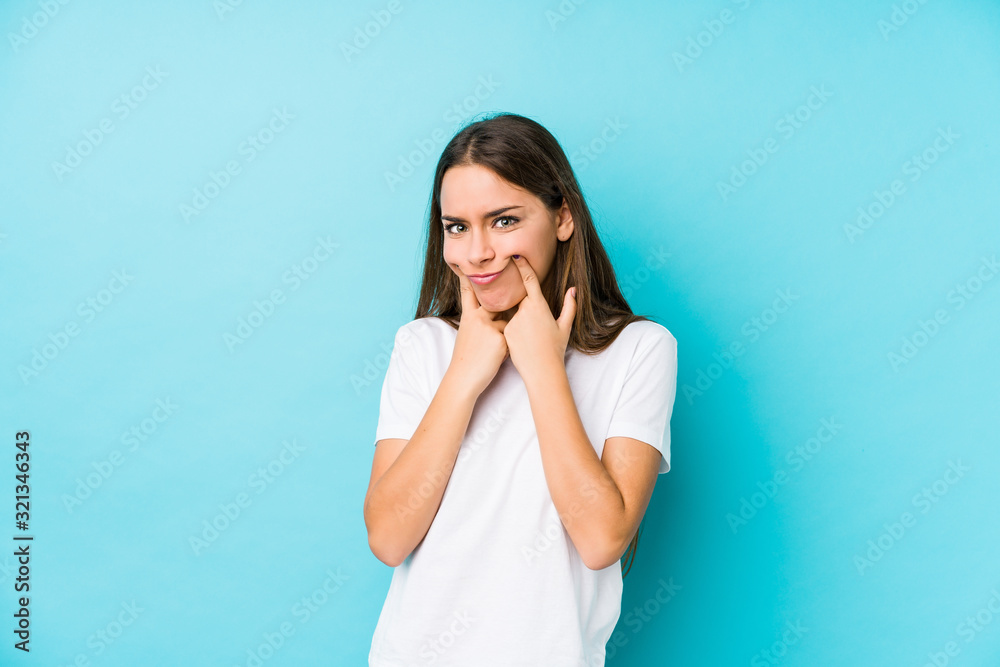 Young caucasian woman isolated doubting between two options. Young caucasian woman isolated doubting between two options.