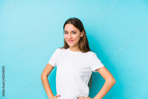 Young caucasian woman  isolated confident keeping hands on hips.