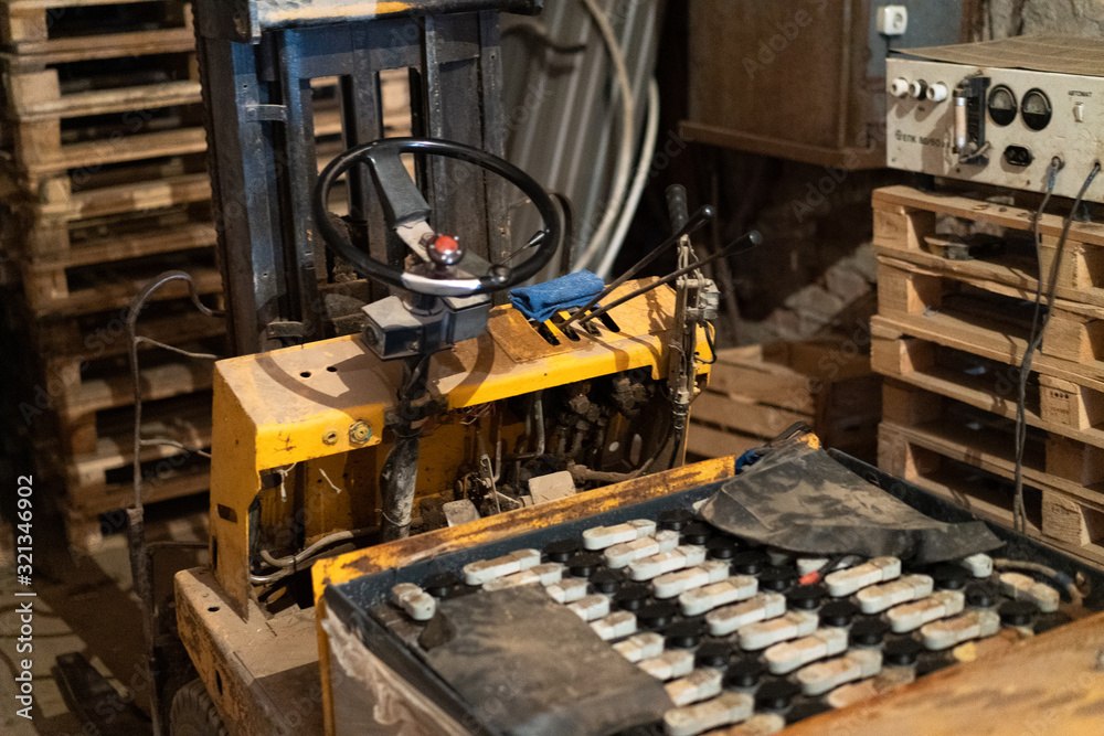 Old forklift, workshop, yellow closeup Old forklift, workshop, yellow closeup