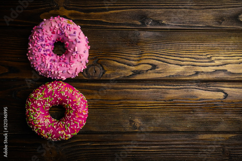 tasty donuts on wooden background