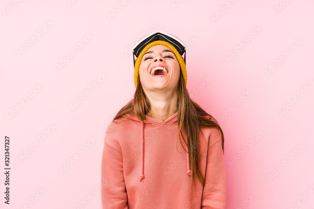 Young caucasian woman wearing a ski clothes isolated relaxed and happy laughing, neck stretched showing teeth. Young caucasian woman wearing a ski clothes isolated relaxed and happy laughing, neck stretched showing teeth.