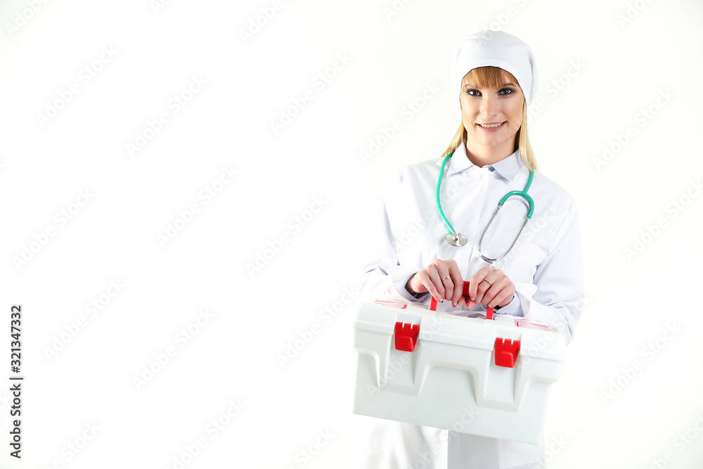 female doctor holding an ambulance first aid kit on gray background