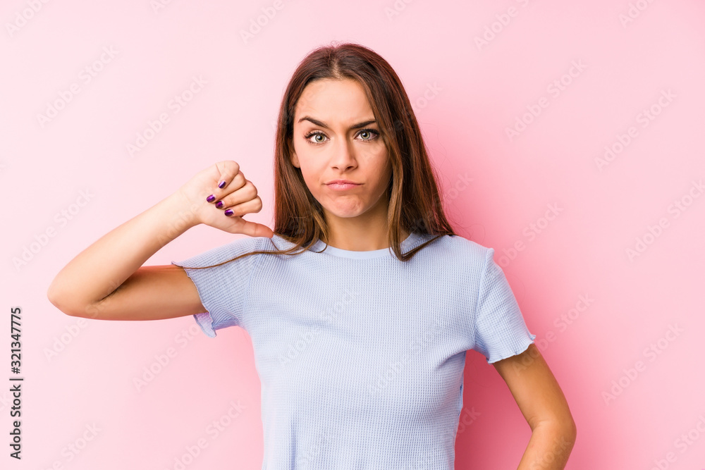 Young caucasian woman wearing a ski clothes isolated showing a dislike gesture, thumbs down. Disagreement concept. Young caucasian woman wearing a ski clothes isolated showing a dislike gesture, thumbs down. Disagreement concept.