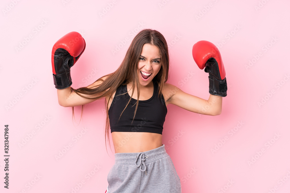 Young caucasian sporty woman boxing