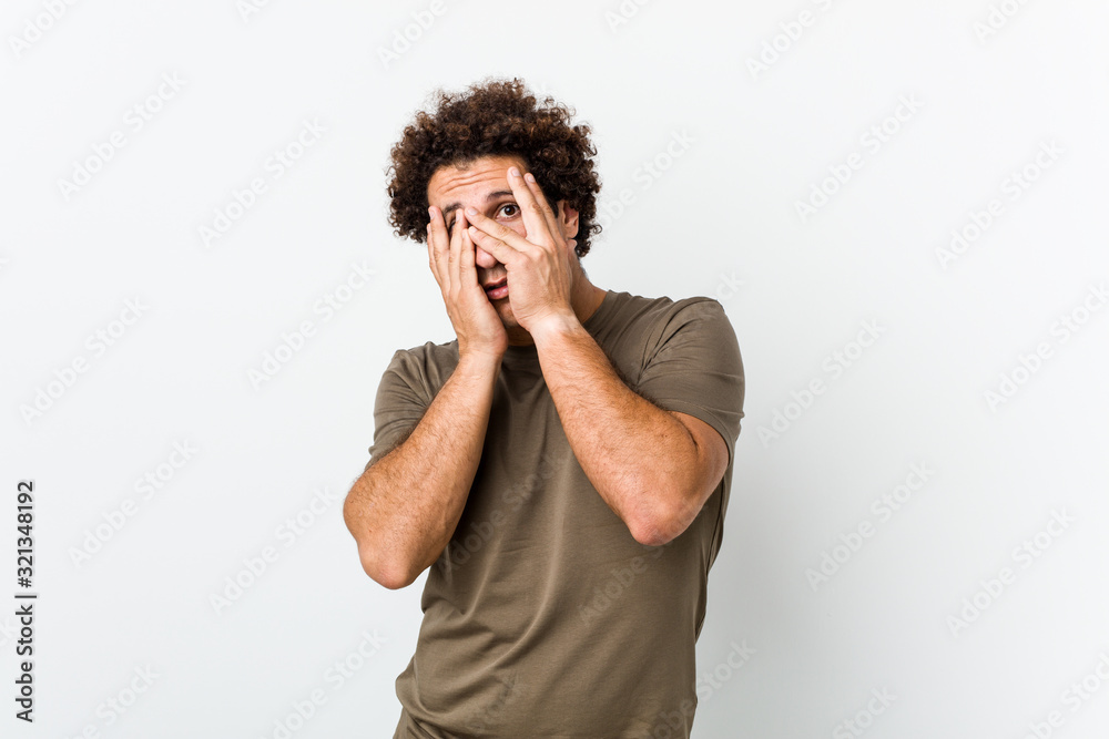 Mature handsome man isolated blink through fingers frightened and nervous. Mature handsome man isolated blink through fingers frightened and nervous.