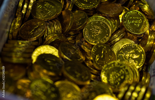 Candy in the form of coins in a box photo