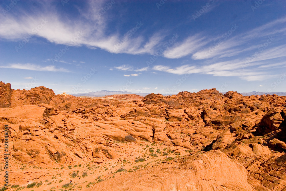Scenic view of orange desert rocks against a blue sky in the southwest USA