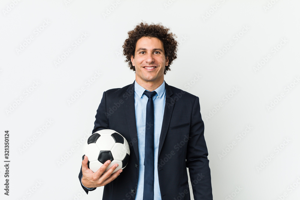 Soccer trainer holding a ball happy, smiling and cheerful. Soccer trainer holding a ball happy, smiling and cheerful.