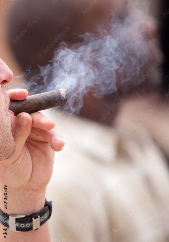 Caucasian man smoking a cigar