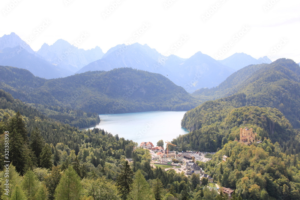 mountain village on lake with castle