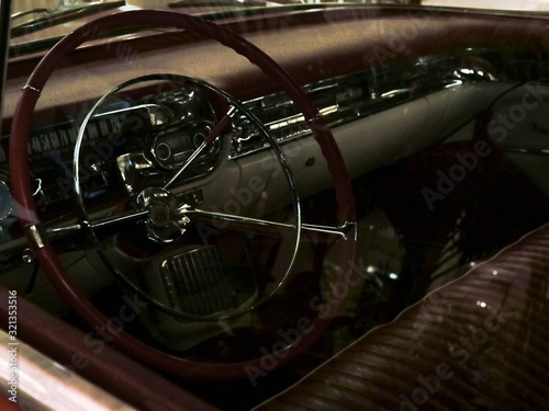 interior of an old car through the glass of the driver's door, red car