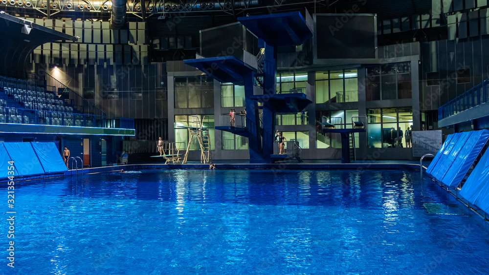 Public swimming pool with jump tower and classic blue water. Sport concept. Public swimming pool with jump tower and classic blue water. Sport concept.