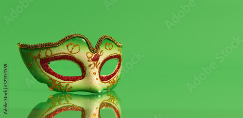 Festive, colorful masks of Mardi Gras or carnival mask on green background. Venetian masks.