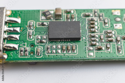 USB wifi adapter. Green printed electronic circuit board having small electronic components and chips.
