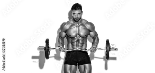 Handsome Bodybuilder Lifting Weights. Performing Biceps Curls