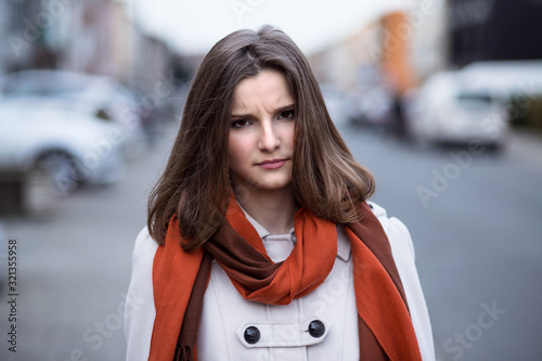 Unhappy wife. Angry woman outside in the city of Brussels Belgium looking at you camera children husband about to yell scold