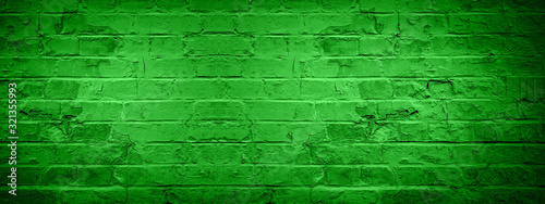 Green damaged rustic brick wall texture banner panorama, colorful trend color 2020 germany
