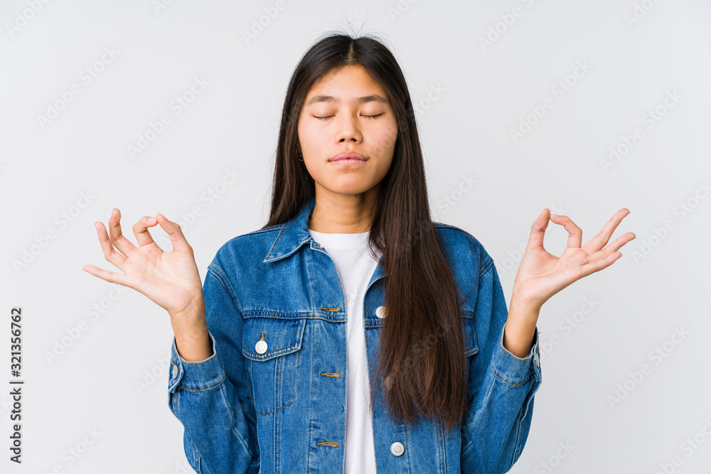 Young asian woman relaxes after hard working day, she is performing yoga. Young asian woman relaxes after hard working day, she is performing yoga.