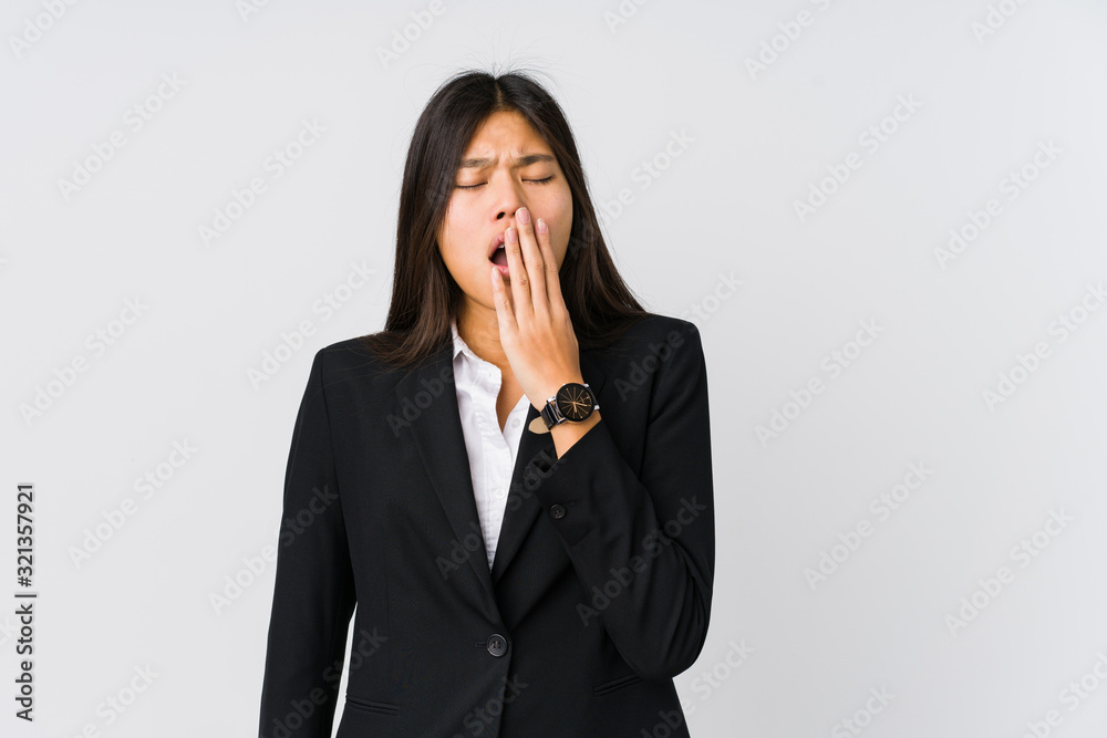 Young asian business woman yawning showing a tired gesture covering mouth with hand. Young asian business woman yawning showing a tired gesture covering mouth with hand.