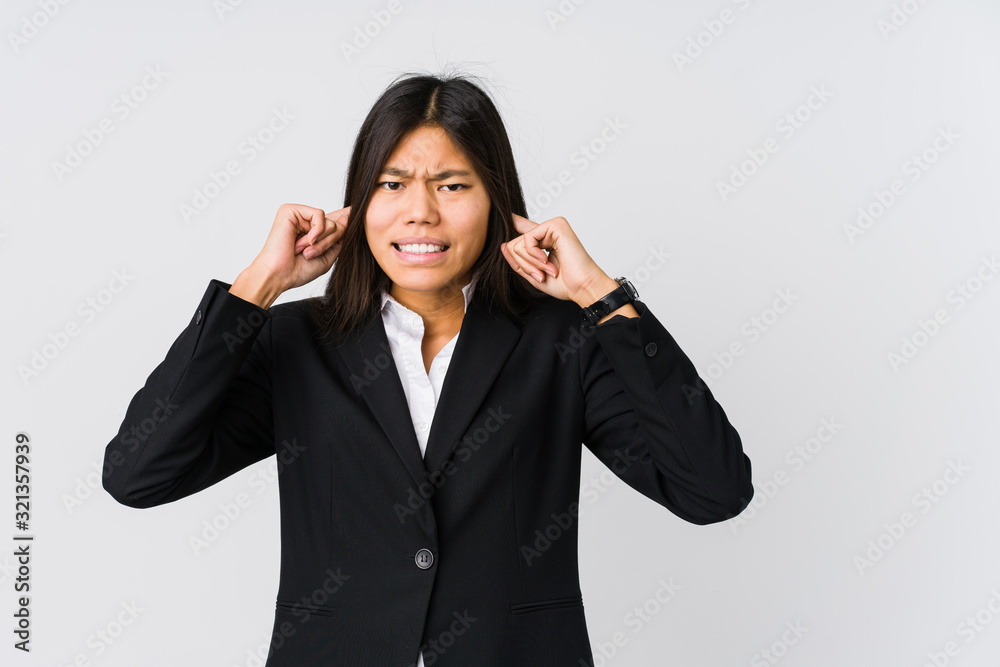 Young asian business woman covering ears with hands. Young asian business woman covering ears with hands.