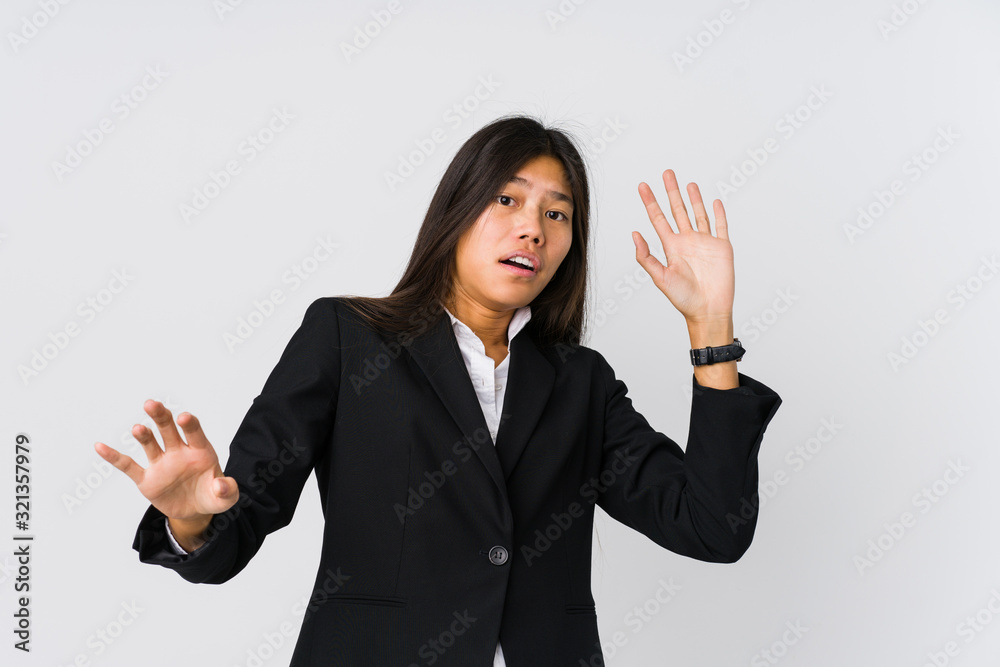 Young asian business woman being shocked due to an imminent danger Young asian business woman being shocked due to an imminent danger