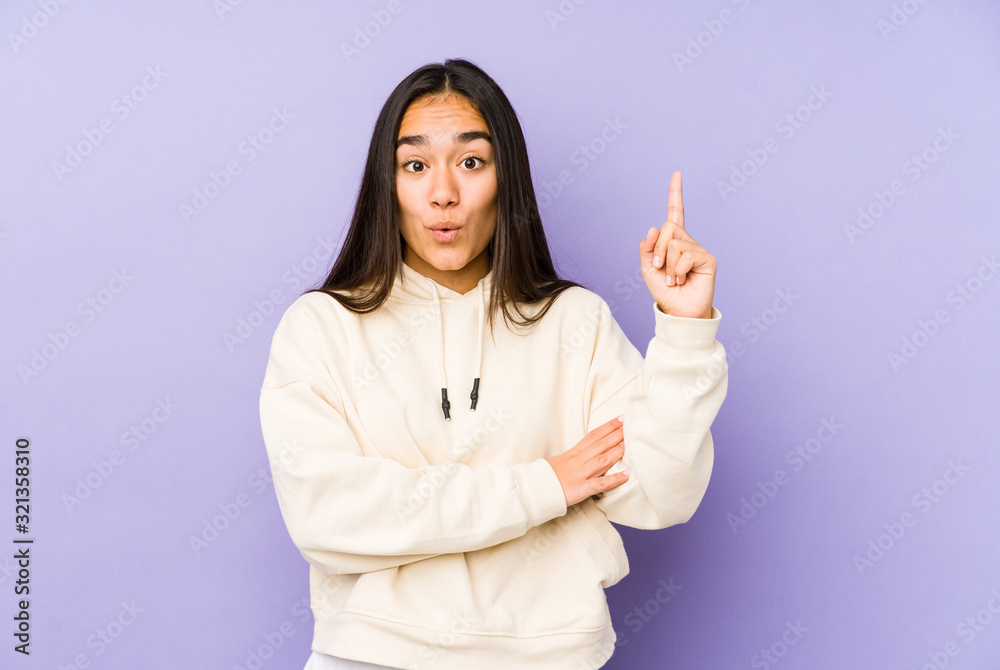 Young woman isolated on a purple background having some great idea, concept of creativity. Young woman isolated on a purple background having some great idea, concept of creativity.