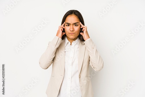 Young woman isolated on a white background focused on a task, keeping forefingers pointing head.