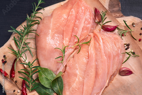 Raw sliced chicken meat close-up.Close-up view of raw, fresh, choped and sliced chicken meat. Sottilissime. Delicious dietary meat. Cooking. photo