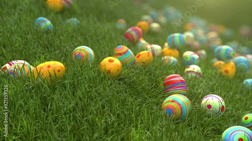 Easter eggs on the grass. Easter eggs slide down the slope covered with green cereal. Sunny positive climate. Beautiful surroundings and cheerful animation.