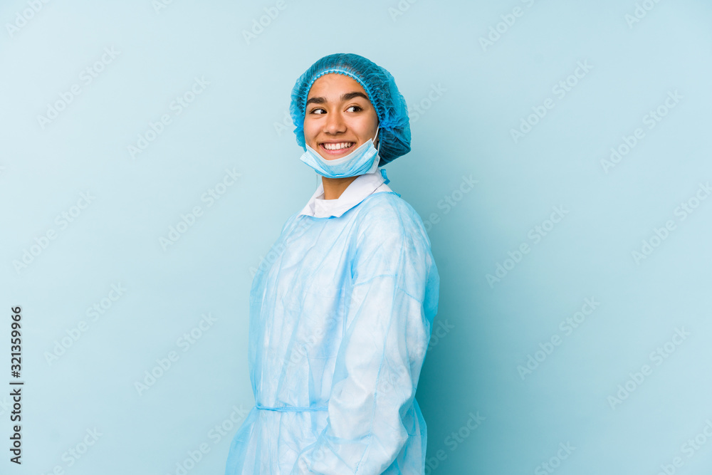 Young surgeon asian woman isolated looks aside smiling, cheerful and pleasant. Young surgeon asian woman isolated looks aside smiling, cheerful and pleasant.
