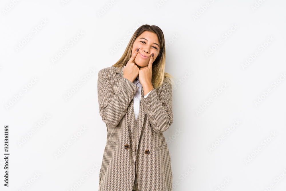 Young caucasian business woman isolated doubting between two options. Young caucasian business woman isolated doubting between two options.