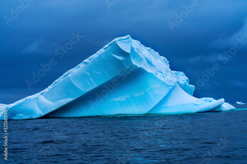 Floating Blue Iceberg Snow Glaciers Charlotte Harbor Antarctica © Bill Perry