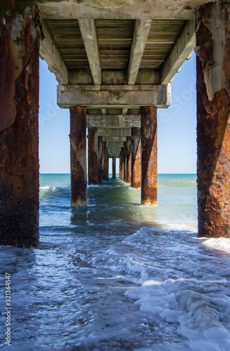 Calm ocean water view under pier